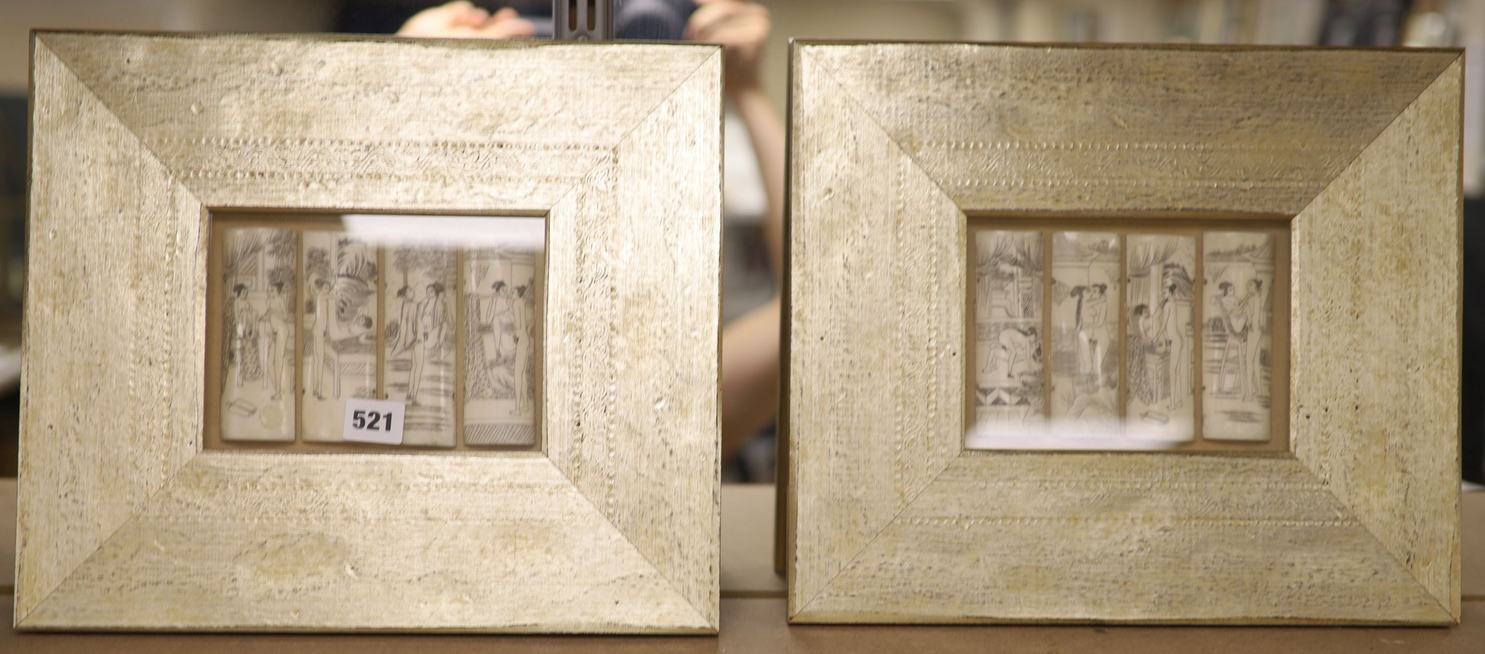 A pair of case framed cut bone panels, decorated with erotic scenes